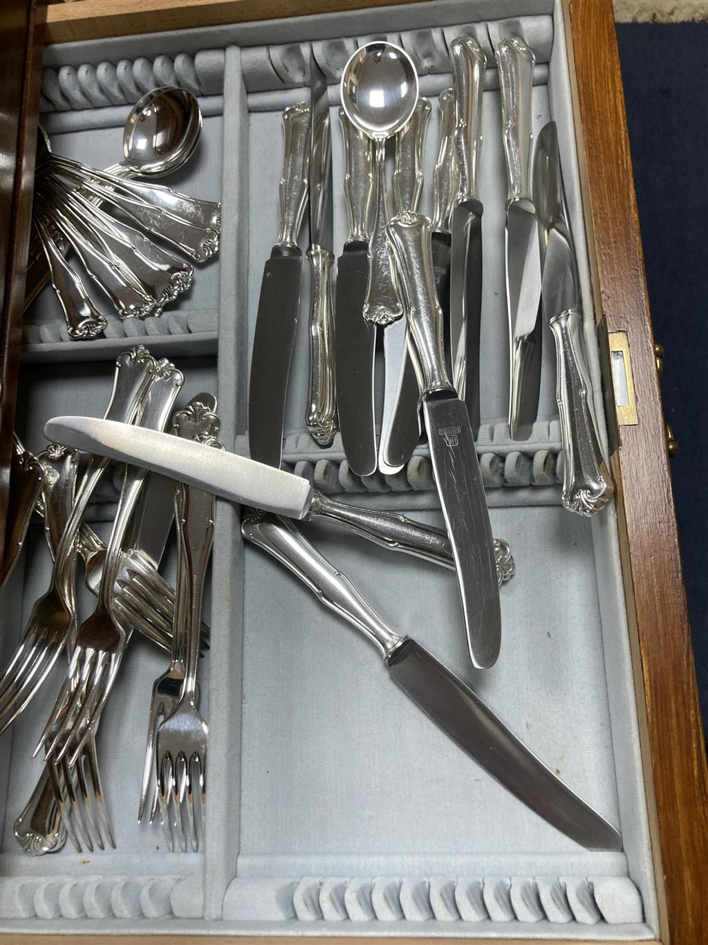 A canteen of plated cutlery contained a fitted case, settings for twelve